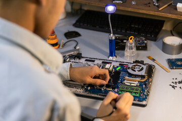 Fototapeta na wymiar technician soldering a broken computer board