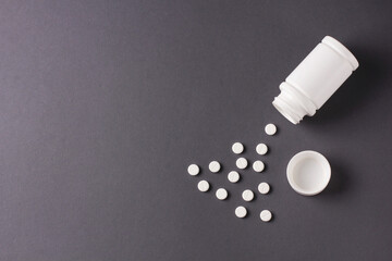 white pills on grey background