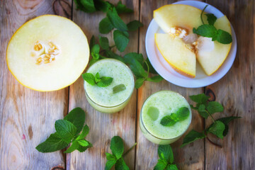 Smoothie melon mint in glasses on a wooden surface. Summer refreshing drink. Detox drink.