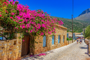Fototapeta na wymiar Scenic view from the picturesque seaside village Limeni. Traditional houses and colorful stoned buildings in Limeni, Mani area, Laconia, Greece