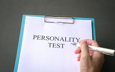 Job applicant to do personality test. On dark grey tabletop. - obrazy, fototapety, plakaty
