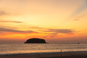 scenery yellow sky the sun going down to the sea..beautiful golden sky at sunset in Kata beach Phuket Thailand.high quality image for travel concept.