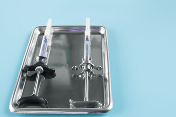 Dentistry medical tools syring on blue background.