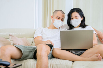 Young couple using a laptop during self isolation