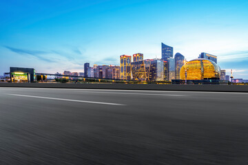 Fototapeta premium Skyline of Asphalt Pavement and Nightscape of Modern Architectural Landscape