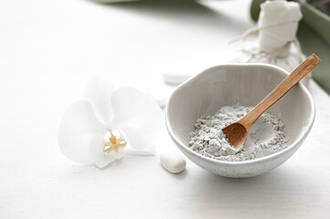 Spa composition with powder face mask and orchid flower.
