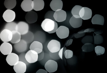 Abstract glitter light bulb with balck and white bokeh pattern background.