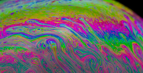 Abstract colourful background with patterns and rainbow effects in soap bubbles.	