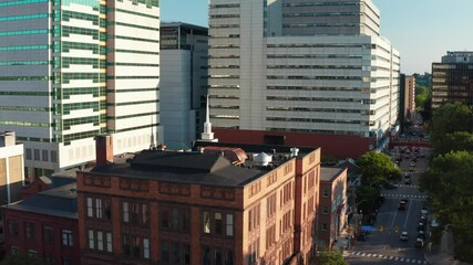 Rising aerial of city skyscrapers in USA during golden hour. American cityscape during magic hour sunset. Busy financial district.