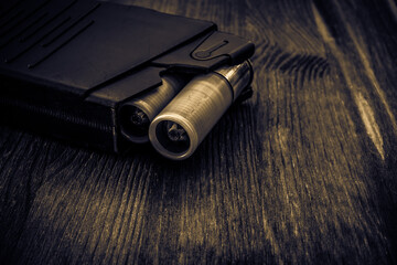 Magazine with bullet cartridges 12 gauge on the wooden table. Close up view