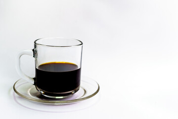black coffee in a clear glass on a white background