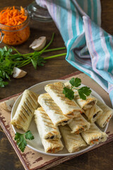 Fast breakfast. Bread toast roll sandwich with mushrooms and carrots spices on a rustic table.