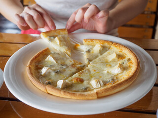 Woman eating pizza and chicken