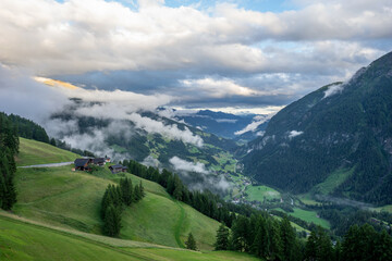 Obraz premium Fog moves up from the valley in the Alps. Austria