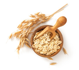 Oat flake in wooden bowl with spoon and spikelets of oats isolated. Bowl of oats on white...