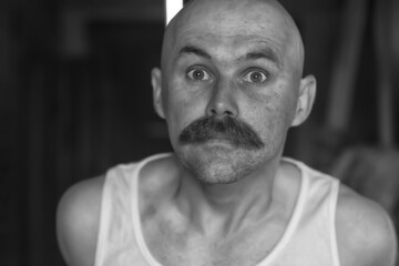 unusual portrait of a bald mustachioed young gentleman, eccentric mister, psychology concept