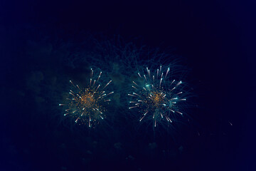 Blurred multicolored fireworks lights against the dark night sky