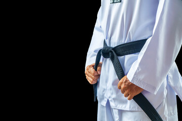 Taekwondo traditional man hand hold black-belt on black background for advertising. The karate man standing with black belt isolated on black with copy space. © kaew6566