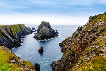 Rugged landscape at Malin Head, County Donegal, Ireland. Rough beach with cliffs, green rocky land...