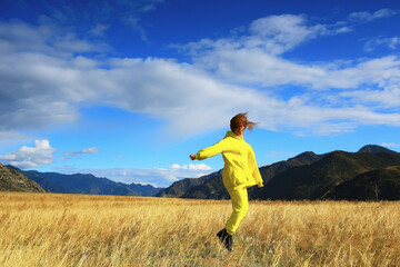 Fototapeta premium field mountains jumping girl active lifestyle outdoor, freedom happiness summer