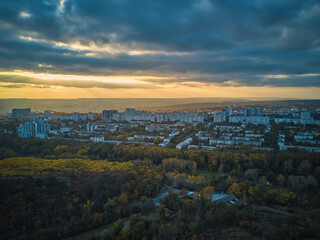 Aerial over the city in autumn at sunset.