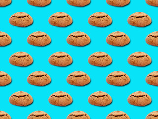 Seamless pattern with cookies. Oatmeal cookies on a blue background.