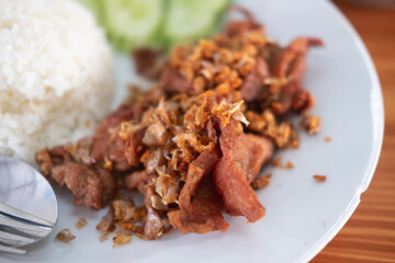 Fried pork with garlic, pepper on rice. Easy Thai food.
