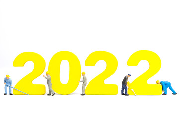 Miniature people worker team build number 2022 , Happy new year concept
