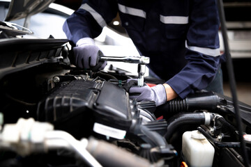 Fototapeta na wymiar Auto mechanic working on car engine in mechanics garage.Repair service,car service, repair, maintenance concept.