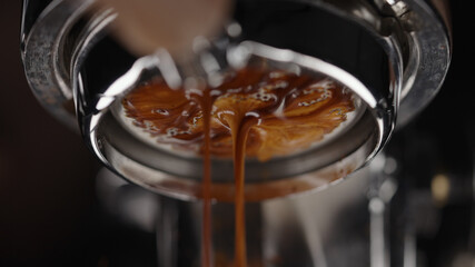 low angle of pulling espresso shot with naked portafilter