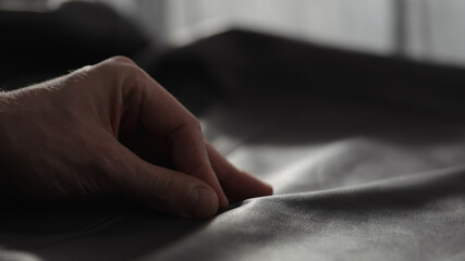 Closeup man touching fine leather