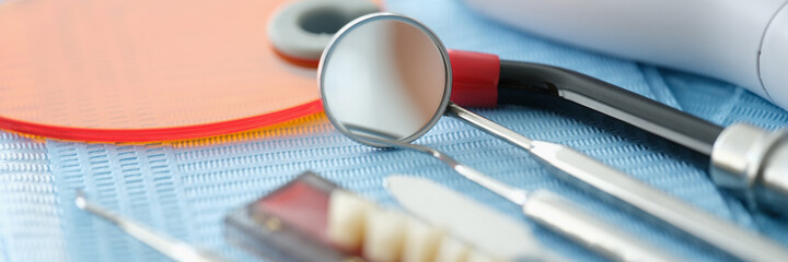 Set of dentures dental tools and curing light on table