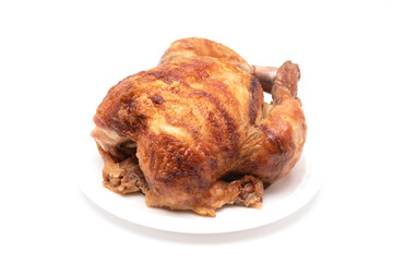 Roasted whole chicken on white plate on white background