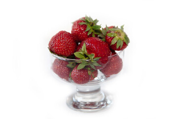 large strawberries in a glass bowl on a white background