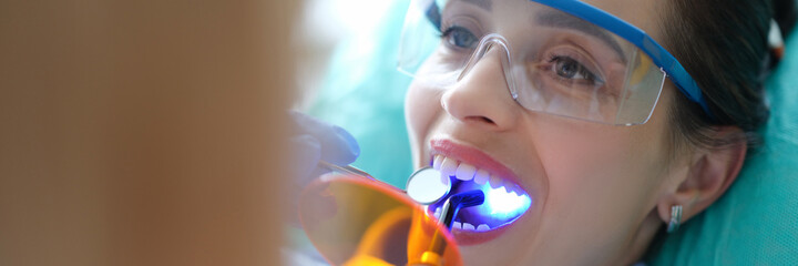Patient visiting dentist for regular check-up and filling teeth closeup