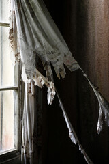 Worn curtains in old, abandoned farm house in Southern Finland. 