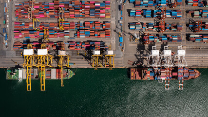 Container ship loading and unloading in deep sea port, Aerial top view