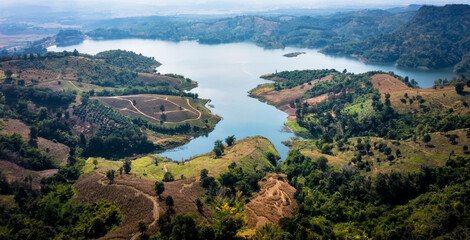 Fototapeta premium national reservoir or dam in the middle of the valley at chiang rai Thailand aerial view