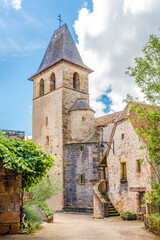 Fototapeta na wymiar View at the Bell tower of Churchh Of Saint Jean Baptist in the streets of Loubressac - France.