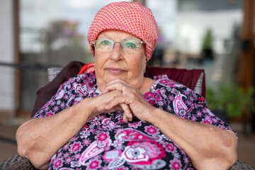 Portrait of a beautiful old woman with gray hair and glasses
