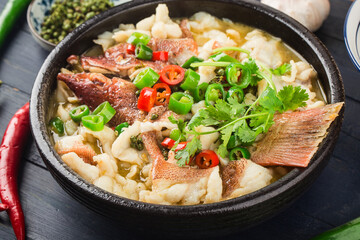 Chinese food:boiled fish with pickled cabbage and chili. Red grouper fillets