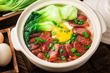 Cantonese style cooking of claypot rice with waxed meats