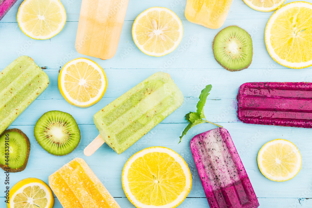 Poster Healthy Whole Fruit Popsicles with Berries Kiwi watermelon cantaloupe on wooden vintage table