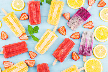 Healthy Whole Fruit Popsicles with Berries Kiwi watermelon cantaloupe on wooden vintage table