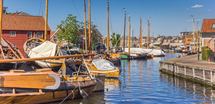Panorama of traditional wooden ships in the central canal of Spakenburg