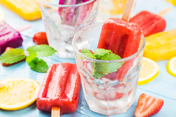 Healthy Whole Fruit Popsicles with Berries Strawberry orange  Dragon fruit  on wooden vintage table