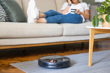 Robot vacuum cleaner cleaning the living room.