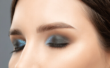 Beautiful woman with long eyelashes, beautiful make-up and thick eyebrows. Professional makeup and...