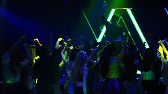 Women and men have fun in dance party. Group of young people dancing in night club.