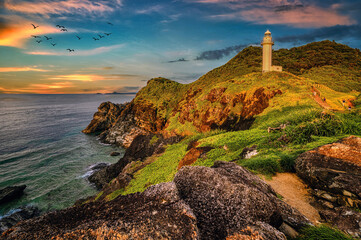 A lighthouse on a cliff on the island of Ishigaki, Okinawa, seen at sunset